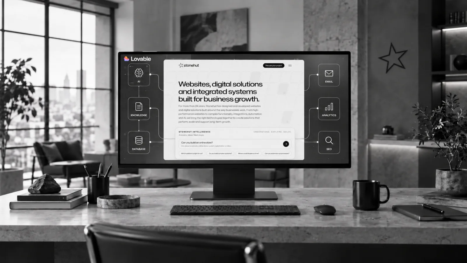 Stonehut website displayed on a desktop monitor with connected AI, knowledge base, database, email, analytics and SEO systems.